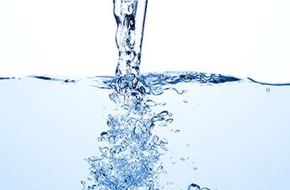 Light blue tinted water being poured