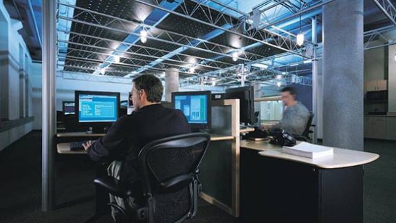 Two men working on computers in an office