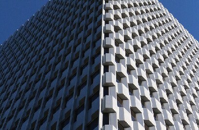 A white, modern building against the sky