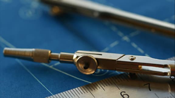 A metal ruler scale and a compass on a blue map