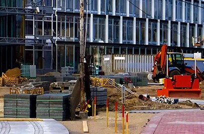 A construction site outside a glass building