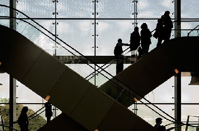 Silhouette of people on escalators inside a building