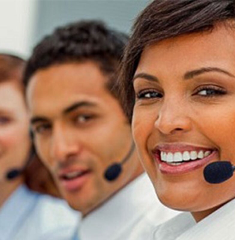 four people wearing headphones  looking at camera