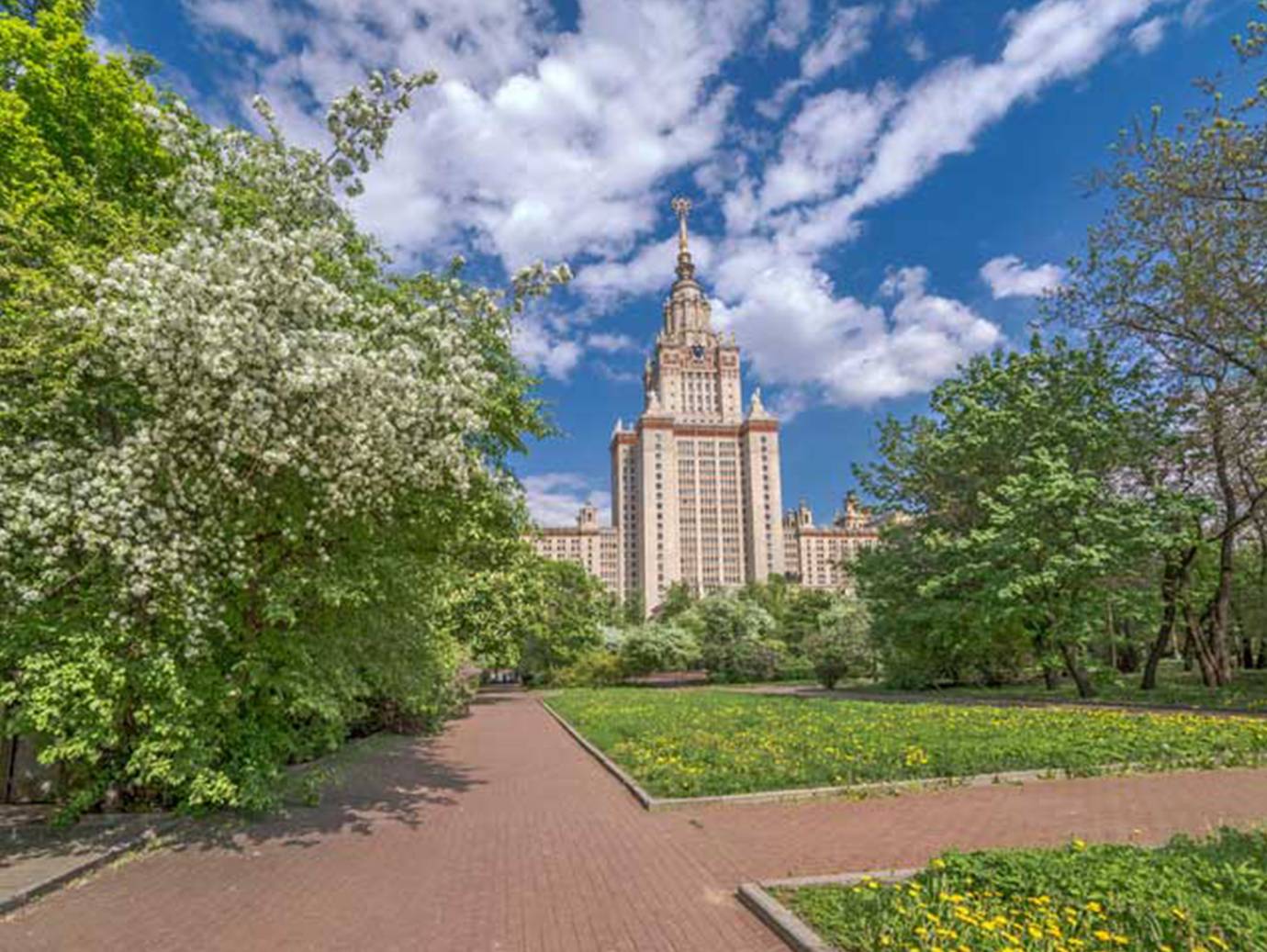 Close-up of a university campus, with the building's tower visible in the background