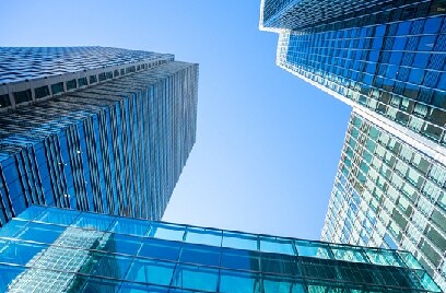 Upwards shot of a skyscraper with glass windows at dusk
